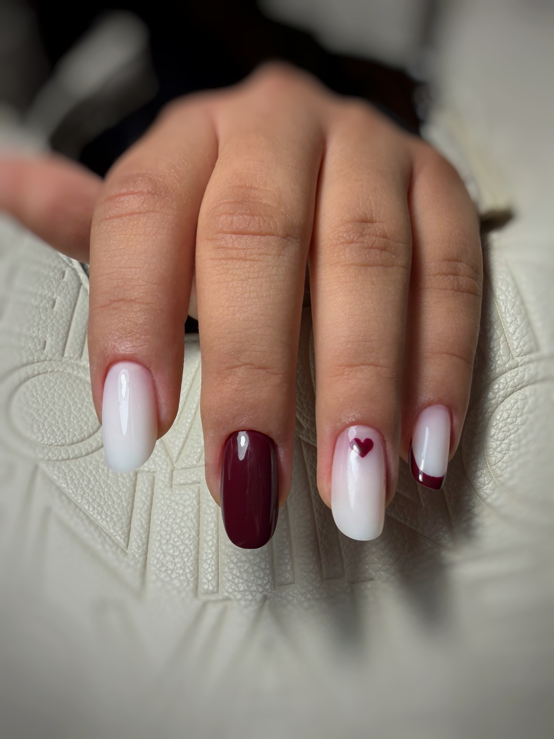Sophisticated bridal nails in soft white with delicate pearl shimmer and rhinestones.