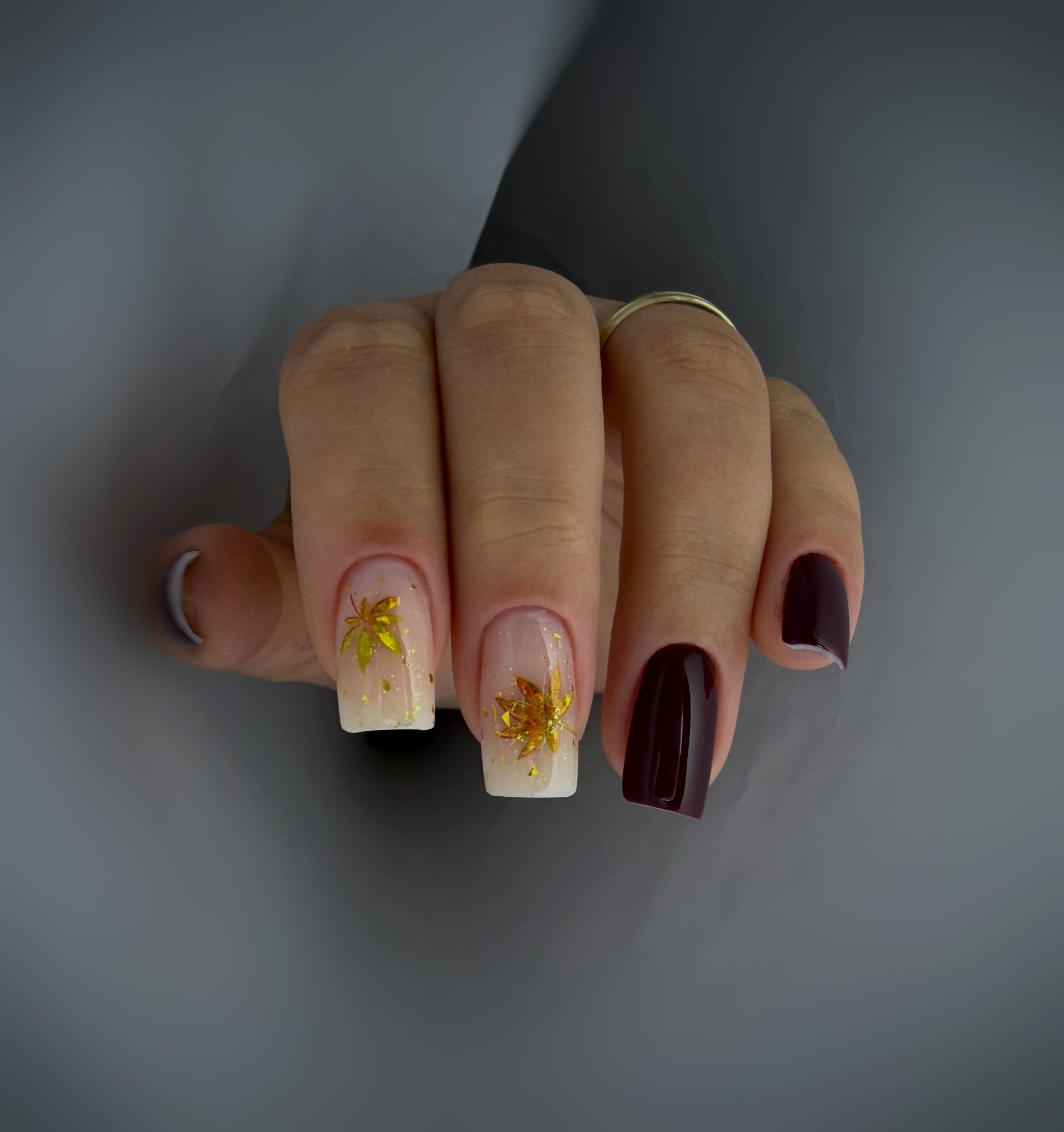 Durable gel polish manicure on short natural nails in a rich winter berry shade.